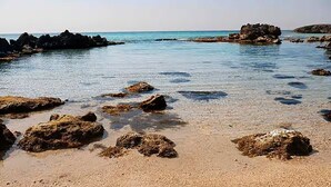 A beach with scattered rocks and clear water. - Luxurious beach villa in Apulia (Marina di Pulsano)