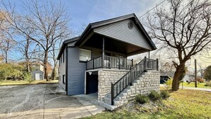 A two-story house with a stone staircase and a covered front porch. - Cute & Cozy House in Quiet Blue Ash Neighborhood (Blue Ash)
