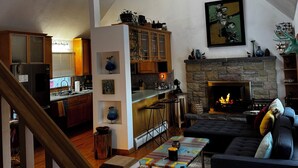 A spacious living area with a high ceiling, a fireplace, and a kitchen in the background. - 3bed 3bath sleeps 8 @ Hidden Valley is a ski in-out oasis steps for the action.  (Somerset)