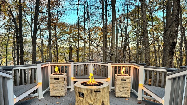 A deck with a central fire pit surrounded by stone planters, set against a backdrop of trees. - 3bed 3bath sleeps 8 @ Hidden Valley is a ski in-out oasis steps for the action.  (Somerset)
