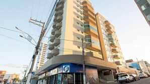Un edificio de varias plantas con un diseño moderno, que cuenta con balcones en cada nivel.