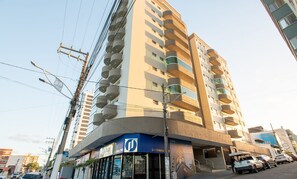 Ein mehrstöckiges Gebäude mit modernem Design, mit Balkonen auf jeder Etage.