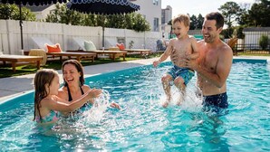 A swimming pool with lounge chairs and umbrellas in the background. - Golf Sim, Theater, Games, Walk to Beach, Sleeps 28 (North Myrtle Beach)