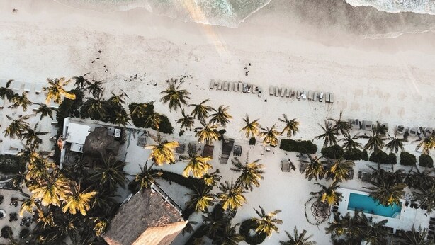 An aerial view of a beach resort with palm trees, a pool, and a beachfront area. - Paradise Villa, 3 Pools, Rooftop, VIP Concierge (Tulum)