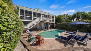 A house with a swimming pool, outdoor furniture, and a covered patio area. - Historic Retreat Near Beach w/ Pool 306 Charleston Blvd Roosevelt Retreat by Avantstay (Isle of Palms)