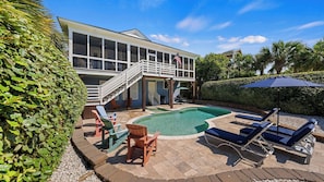 A house with a swimming pool, outdoor furniture, and a covered patio area. - Historic Retreat Near Beach w/ Pool 306 Charleston Blvd Roosevelt Retreat by Avantstay (Isle of Palms)