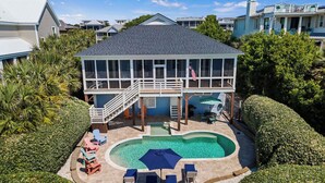 A two-story house with a pool, deck chairs, and a flag. - Historic Retreat Near Beach w/ Pool 306 Charleston Blvd Roosevelt Retreat by Avantstay (Isle of Palms)