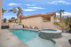 A residential property with a swimming pool, a hot tub, and a covered patio area. - The Game Table Getaway | Pool, Spa & Games (Indio)