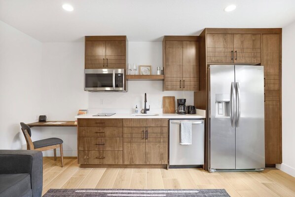 A modern kitchen with wooden cabinets, stainless steel appliances, and a built-in dishwasher. - Relaxing Casita with immaculate views in fantastic Hurricane location (Hurricane)