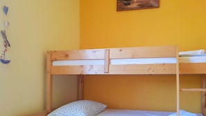 A bunk bed with a wooden frame and a mattress.