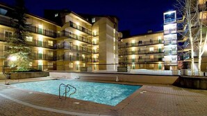 A multi-story hotel with a swimming pool, outdoor lighting, and balconies. - Amazing Lionshead 2 bd/2ba condo. Walk to slopes and shops. Amazing Hot Tub! (Vail)