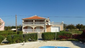 A two-story house with a balcony, a garage, and a swimming pool. - Amazing Villa with Outdoor Swimming Pool (Stankovci)