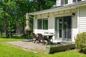 A house with a patio, a table, and chairs. - Country Chic 3BR Retreat Near All Star Village (Treadwell)