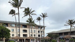 A resort with a pool, palm trees, and a building with balconies. - Hilton Point At Poipu Relaxing 2-bedroom resort with AC in awesome Koloa (Koloa)