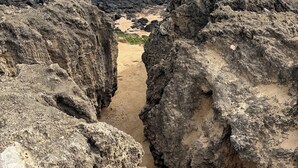 A rocky coastal landscape with a narrow sandy path between large boulders. - Hilton Point At Poipu Relaxing 2-bedroom resort with AC in awesome Koloa (Koloa)