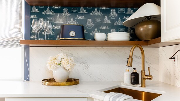 A kitchen with a marble countertop, a gold faucet, a vase with flowers, and a blue decorative box. - Emerald Clover<>3BR, 1Bath House- 1 mile from ND (South Bend)
