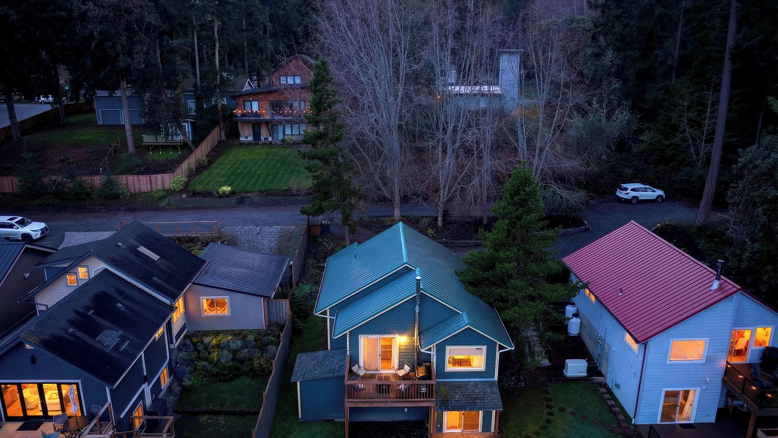 A residential area with houses, a driveway, and a street.