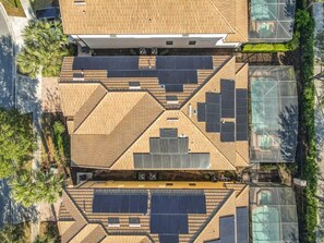 A rooftop with solar panels and a greenhouse structure. - Spacious 8BR Luxury Home, Pool,Spa, By Disney (Kissimmee)