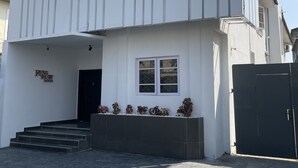 A modern building with a sign reading "Ring Ruby Hotel" and a staircase leading to the entrance. - Ringruby Hotel Value County (Lekki)