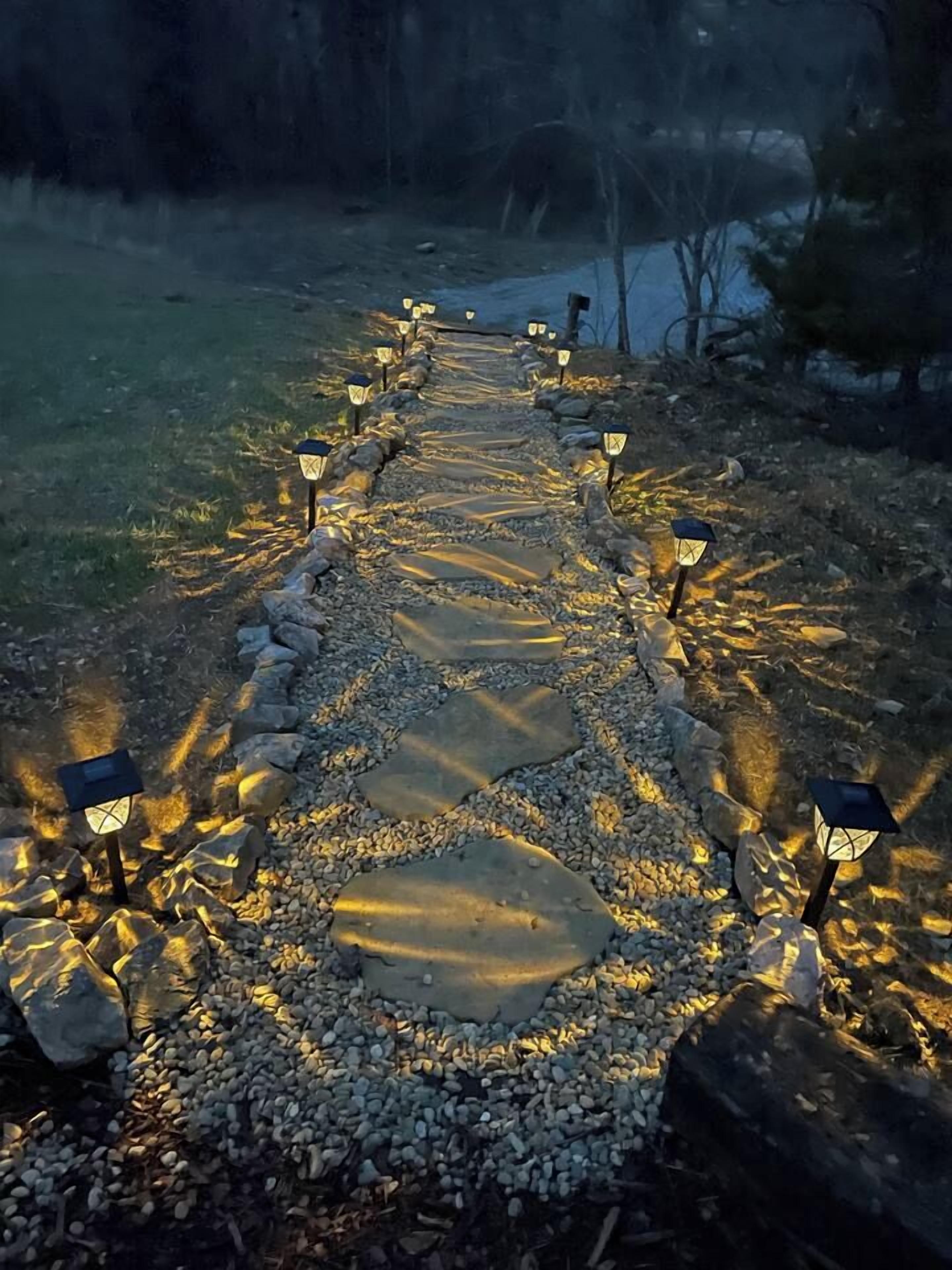 A pathway with evenly spaced lanterns and stone slabs.