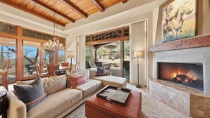 A spacious living room with a fireplace, large windows, and a cozy seating area. - 3BR Luxury Villa @ The Rocks, Pool,Troon Golf, Spa, Daily Cleaning, Clubhouse (Scottsdale)