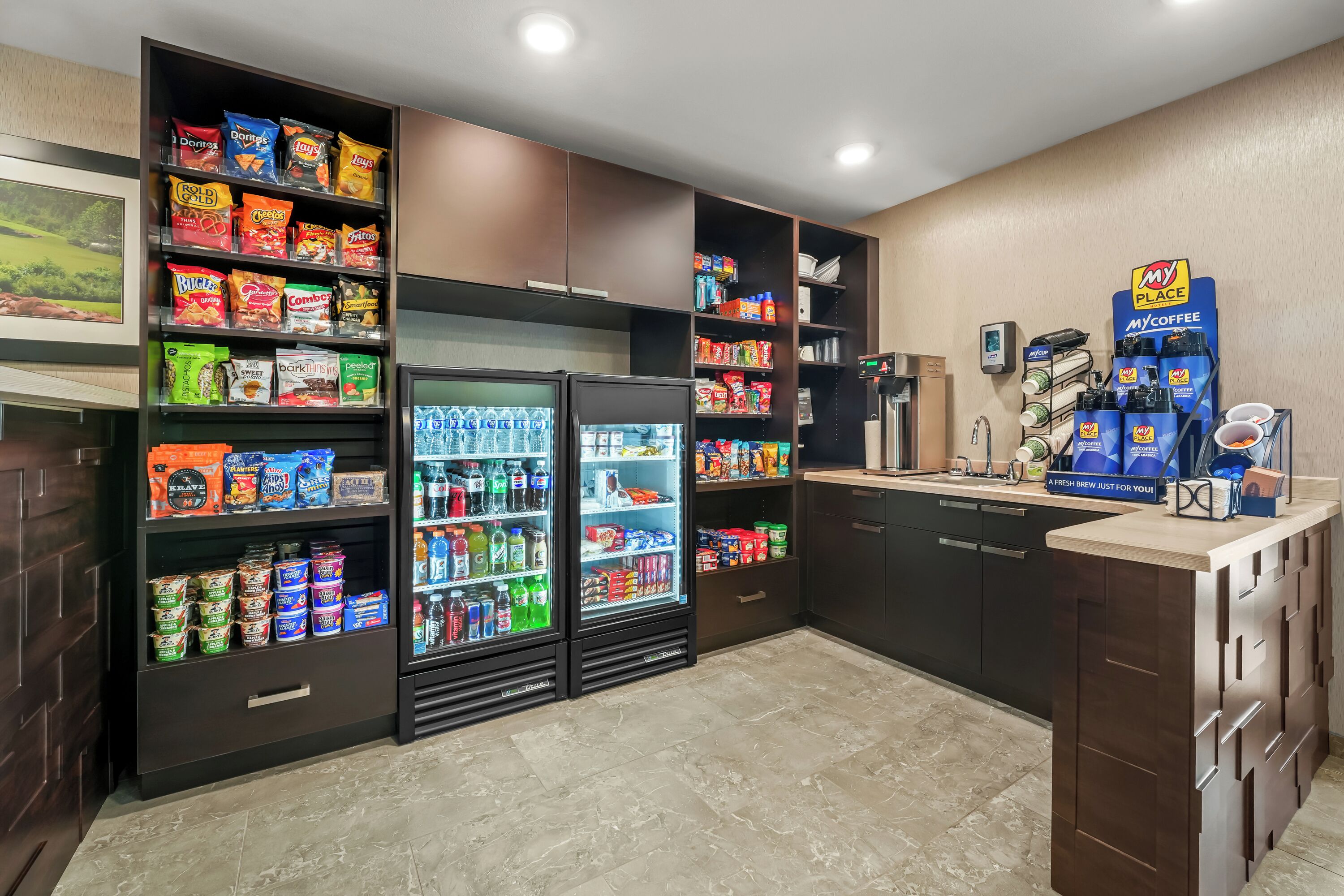 A self-service kiosk area with snacks, beverages, and MyCoffee machines.
