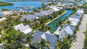 A coastal residential area with houses, a marina, and a large swimming pool. - Gorgeous Coral Lagoon Villa - Top Rated Resort in Marathon w/ Boat Slip -Amazing (Marathon)