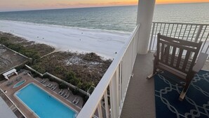 A balcony with a view of the beach and ocean at sunset. - Direct Beachfront, Largest Balcony,4BR-4Ba, Bunks, 2 Master Beds, Full Remodel (Panama City Beach)