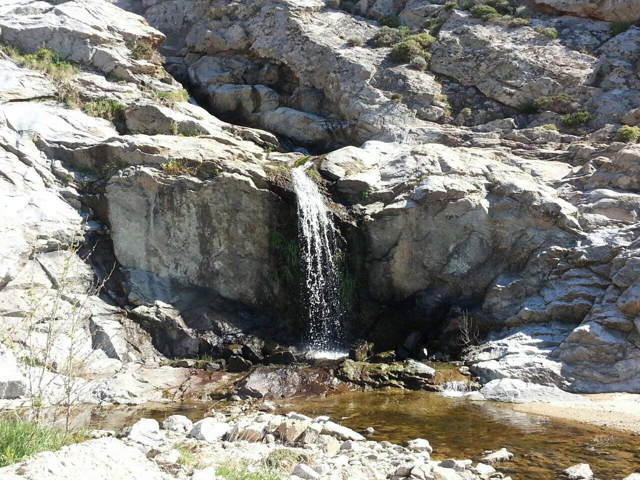 A natural rock formation with a small waterfall.