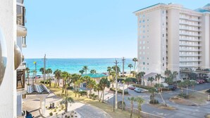 A high-rise hotel with a view of the ocean and palm trees. - 3 Bd/3Ba GULF views! Comp Beach chair set-up! (Miramar Beach)
