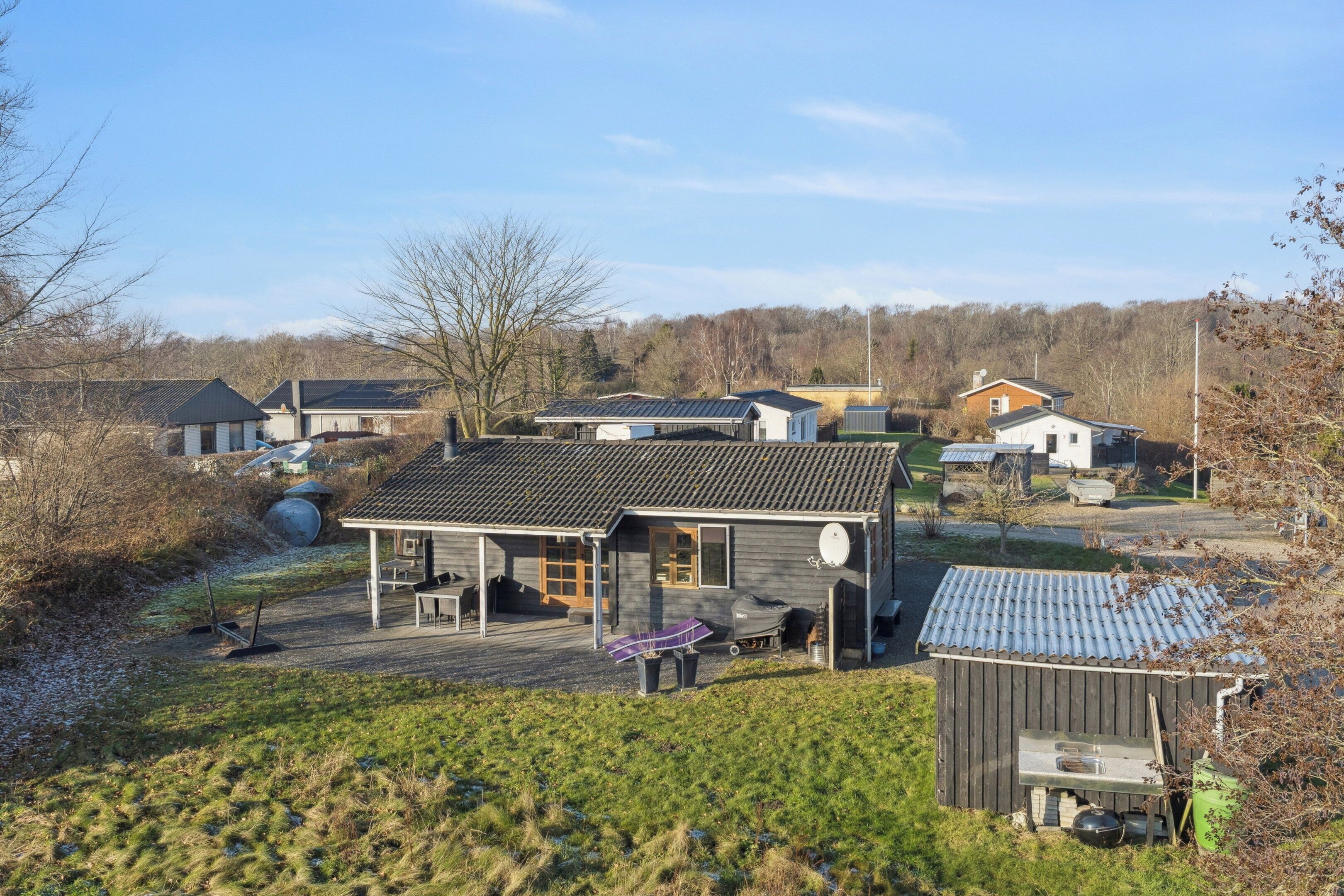A residential area with houses, a covered porch, and a small shed.