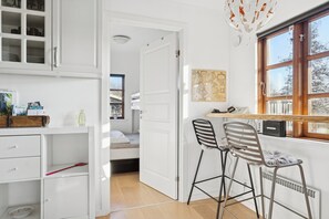 A compact room with a kitchenette, a bed, and a window with a view. - Lovely holiday home near forest and beach (Aabenraa)