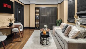 Un salon moderne avec un canapé, une table basse et un téléviseur fixé au mur.