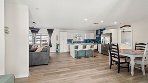 A modern apartment with a kitchen, dining area, and living room. - Beautiful 3BR/2BA - Steps from the Gulf & FREE Boat ramp - Kayaks & bikes incl. (Hernando Beach)