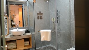 A modern bathroom with a glass-enclosed shower, a white sink, and a mirror above the sink. - GreenTree Inn Fuzhou Sanfang Qixiang  (Fuzhou)