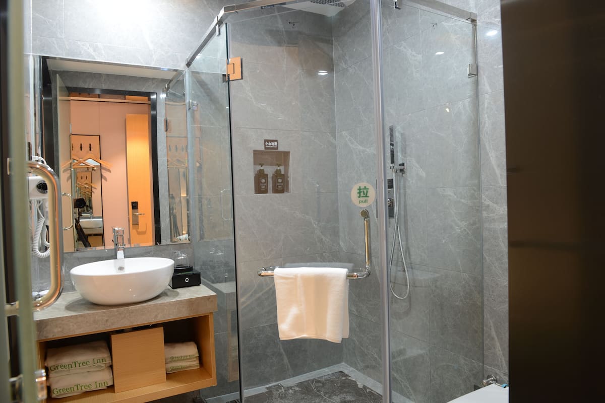 Shower, hair dryer, slippers, towels