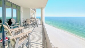 A balcony with outdoor seating and a view of the beach. - The Oasis 1804 | Beautiful, spacious, beach front condo! Endless Amenities! (Orange Beach)