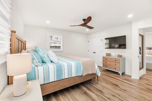 A bedroom with a bed, a dresser, a ceiling fan, and a window with blinds. - Newly Renovated Bayside Retreat - Steps to the Beach (Ocean City)