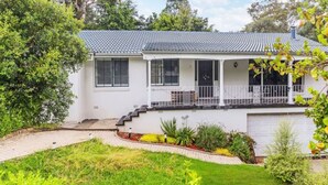 A two-story house with a covered porch, a garage, and a well-maintained garden. - 4BR Castle Hill Home | Garage | Near Mall & Park (Castle Hill)