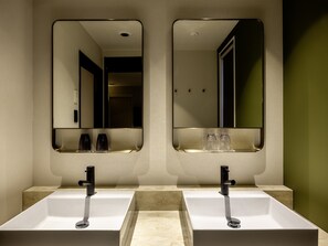 A bathroom with two sinks, each with a mirror above. There are two faucets and two glasses on the counter. - KOKO HOTEL Sendai Station Central (Sendai)