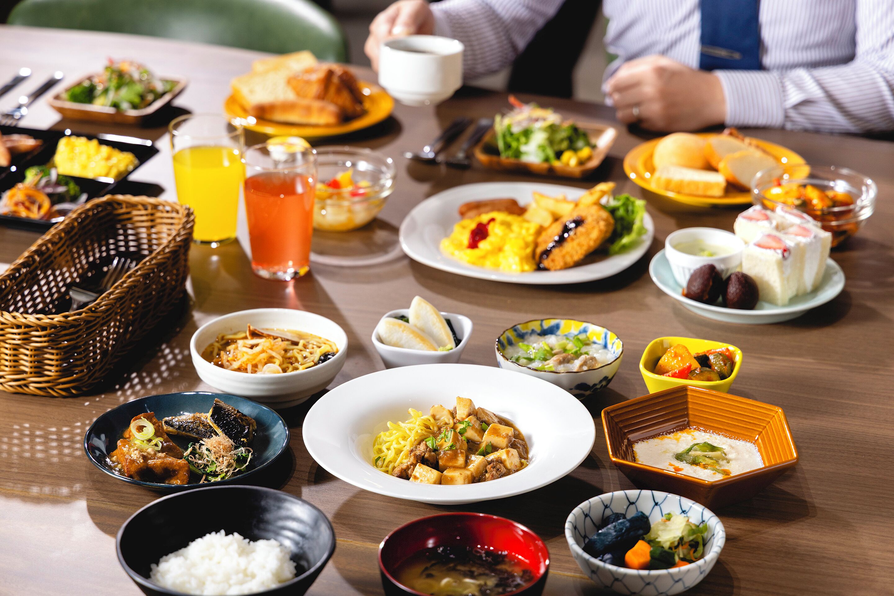 A variety of dishes on a table, including rice, soup, and different types of meat and vegetables.