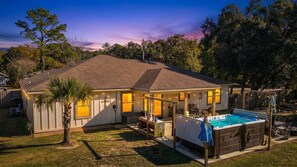 A house with a swimming pool, a covered patio, and a fenced backyard. - Foley Home with Heated Swim Spa and Fenced Yard (Foley)