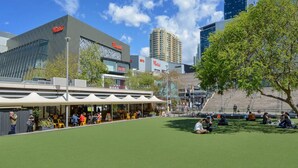 A public square with a restaurant, outdoor seating, and a view of surrounding buildings. - Chatswood walk to Train Station/Shopping center (Chatswood)