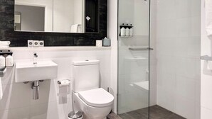 A modern bathroom with a glass shower enclosure, a white sink, and a toilet. - Chatswood walk to Train Station/Shopping center (Chatswood)