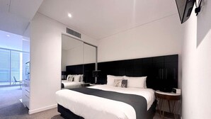 A modern hotel room with a large bed, a bedside table, a chair, and a large window. - Chatswood walk to Train Station/Shopping center (Chatswood)