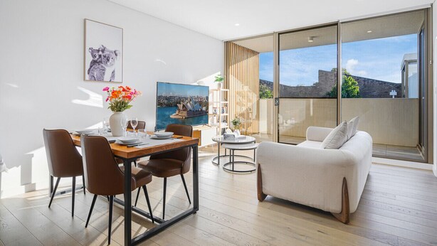 A modern living room with a dining area, a sofa, and a balcony with a city view. - Waterloo 2Br town close to Train/Shopping/Hospital (Waterloo)