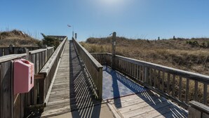 A wooden boardwalk leading to a beach with a clear sky. - Oceanfront Condo, Beach Access, Shared Pool, & Hot Tub (Hatteras)