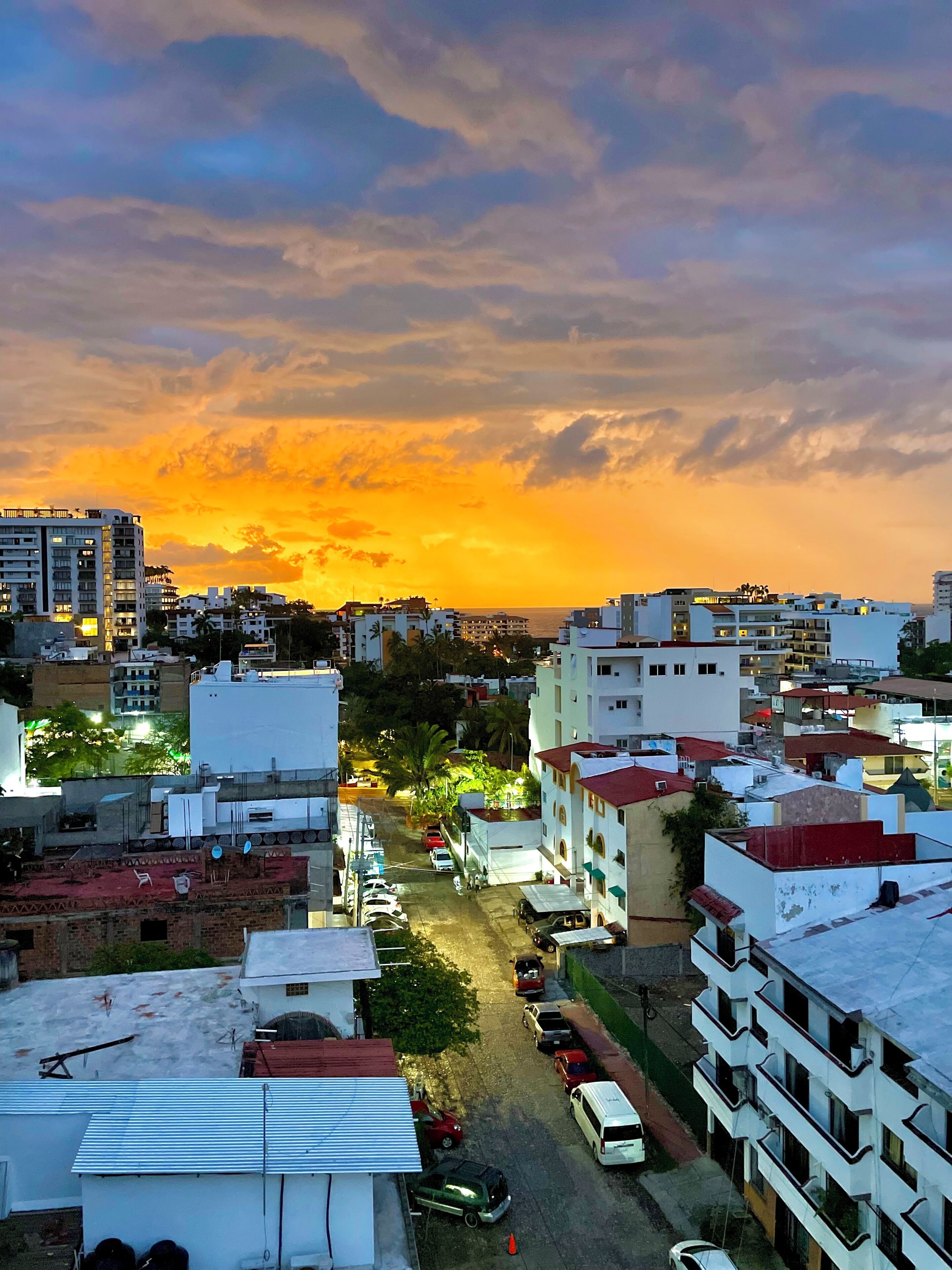 A cityscape with buildings during sunset.