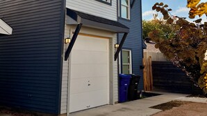 A two-story house with a garage, a visible window, and a tree with autumn leaves in the foreground. - Just minutes from River walk and downtown San Antonio, (San Antonio)