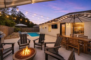 A backyard with a pool, outdoor seating, a fire pit, string lights, and a covered patio area. - 🌴 The Place to Be | Pool | Game Room | Deeded Beach Access ☀️ (Miramar Beach)